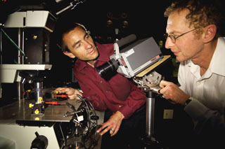 Francois Leonard, left, and Alec Talin (both 8656) measure the thermal properties of a carbon nanotube terahertz detector using an infrared camera. Further technical improvements to the properties of the carbon nanotube material, François says, will lead to an even more effective design and performance of the terahertz detector that he and his collaborators have already achieved. (Photo by Dino Vournas)