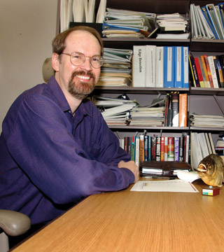 Image of <p>GORDON OSBOURN at the desk in his office at the time of his 2002 appointment as Sandia’s fourth Fellow. Gordon, now retired, was the first Sandian to be designated a Fellow while still an active on-roll researcher.       (Photo by Randy Montoya)</p>