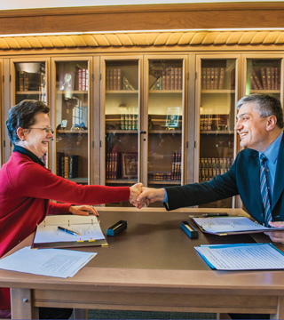 Image of <p>Julia Phillips, Sandia Acting Div. 7000 VP and chief technology officer, and UNM Provost Chaouki Abdallah shake hands after signing the Inter-Institutional Visitors Agreement allowing closer research collaboration.  (Photo by Randy Montoya)</p>