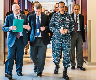 Sandia President and Labs Director Paul Hommert, left, discusses the work of the Microsystems and Engineering Sciences Application (MESA) facility during a Jan. 10 tour for Adm. Cecil Haney, right, commander of US Strategic Command. Among the others on the tour were VP of Science and Technology Div. 1000 Duane Dimos, center; Executive VP and Deputy Director for National Security Programs Jerry McDowell, behind Haney; and Wahid Hermina (1710), senior manager for microsystems research, development, and application/integration, far right. (Photo by Randy Montoya)