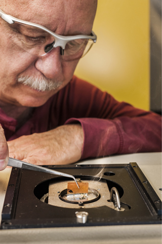 Sandia’s Jerry Rejent (1831) applies lead-free solder to a metal. The solder is hardy, environmentally safe, and low-temperature, and has been sold all over the world. (Photo by Randy Montoya)