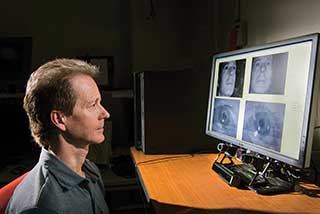 Mike Haass demonstrates the set-up for the FOVIO Eye Tracker, which is placed under a computer monitor to track viewers’ eye movements. The equipment is part of a partnership between EyeTracking and Sandia to develop tools to help intelligence analysts more effectively and efficiently extract useful information from vast amounts of quickly changing data.  (Photo by Randy Montoya)