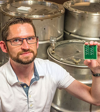 SEALED UP — Jason Hamlet was on the Sandia team that developed SecuritySeal, a device that attaches to a container and detects tampering. The technology, which is based on physical unclonable functions, or PUFs, is available for licensing. “We are looking for commercialization partners,” Jason says. “We want this to be licensed and moved to the next level.” (Photo by Randy Montoya)