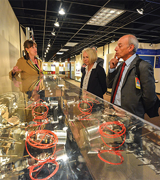 Denis Flory and Anne Harrington examine sensors used in detecting the failure of nuclear reactors at Sandia’s Training and Technology Demonstration Area, inside the Center for Global Security and Cooperation (CGSC), during a tour with sOrg. 6230 senior manager Susan Pickering. Flory and Harrington toured the CGSC as part of the welcoming ceremony for the 25th International Training Course  on the Physical Protection of Nuclear Material and Nuclear Facilities.