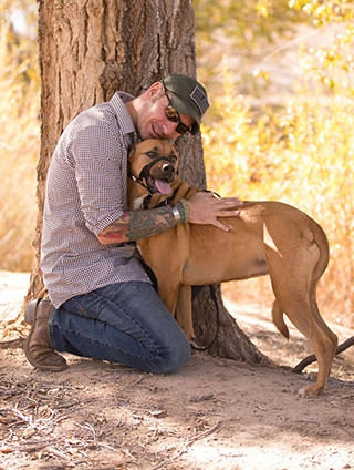 UNCONDITIONAL LOVE — Rob Mitchell, an ES&H Coordinator, will begin bringing his service dog Hunni to Sandia at the end of January. (Photo by Steve Miller)