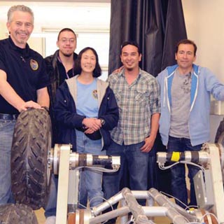 SANDIA PROGRAM MANAGER Jake Deuel (6532) joins Logan Herrera, a senior undergraduate computer science major at NMHU, Sandia senior staff scientist Wendy Amai (6532), NMHU computer science graduate student Miguel Maestas, and chair of NMHU’s computer and mathematical sciences department Gil Gallegos. (Photo by Rick Loffredo/NMHU)
