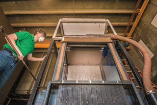 Joshua Mark Christian works with a falling particle receiver, which more efficiently converts the sun’s energy to electricity in large-scale, concentrating solar power plants. (Photo by Randy Montoya)