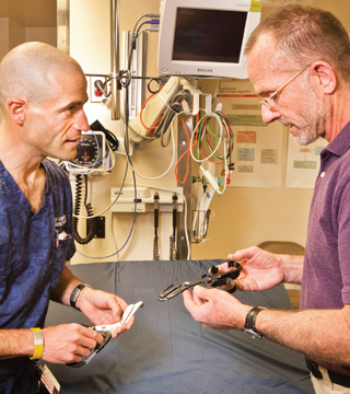 MAKING THE CUT  Sandia researcher Mark?Reece, right, and Albuquerque emergency room physician Scott Forman examine trauma shears developed for Formans company, Héros, under a  New Mexico Small Business Assistance Program project. (Photo by Randy Montoya)