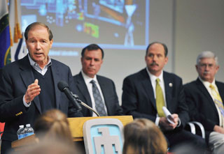 THE TRUTH AS I SEE IT — Sen. Tom Udall presents his views on the challenges facing the US in cyberspace, and what Sandians and CERL can do to help secure that useful but increasingly threatened arena. To the right of the senator are NNSA official Dimitri Kusnezov, Albuquerque Mayor Richard Berry, and UNM Research VP McGraw.
