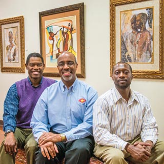 TOP QUALITY — Dennis Owens (424), left, J. Anthony Wingate (422), and Carl Rhinehart (410) were honored with 2013 national Black Engineer of the Year Awards. They met for this photo in the gallery of the African American Performing Arts Center & Exhibit Hall at Expo New Mexico in Albuquerque. The gallery exhibition presented artwork and photos tracing the history of African Americans in New Mexico. The center’s mission is to preserve, nurture, and support the intellectual and cultural history of African Americans in New Mexico and the Southwest. (Photo by Randy Montoya)