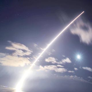 Image of LIFT OFF — A target missile is launched into the night sky from a vertical launcher at Pacific Missile Range Facility tenant, KTF. (Photo by Scott Walkington)