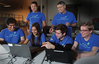 Cyber Technologies Academy Boot Camp developers include, bottom row, left to right: Anuj Kak, Samantha MacIlwaine, Makena Harmon, Evan Laufer (all 8965), and, top row, CW Perr and Steve Hurd (both 8966).(Photo by Dino Vournas)