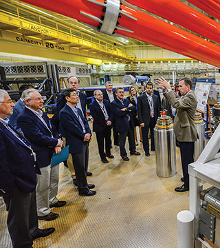 JOEL LASH, senior manager of Z Facility R&D Org. 1670, at right, describes Sandia’s Z pinch capability to an international delegation visiting Sandia to observe firsthand the Labs’ multidisciplinary technical work and learn about the technical infrastructure and workforce that support US implementation of the Treaty on the Non-Proliferation of Nuclear Weapons.