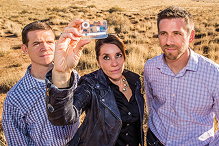 Sandia scientists, from left, Jason Harper (8631), Melissa Finley (6825), and Thayne Edwards (1714) show a BaDx anthrax detector. The three were recognized by the Federal Laboratory Consortium for their work in commercializing the BaDx technology. The detector was licensed by a New Mexico company. 	(Photo by Randy Montoya)