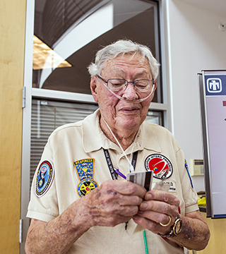 Image of <p>ONE LAST LOOK — As Harold Rarrick prepares to turn in his clearance badge after 65 years, he reflects on two lifetimes’ worth of service to Sandia and the nation. Although Harold, who started at Sandia in October 1949, retired from the Labs in 1993, he remained involved with Sandia as a consultant and senior mentor in the Weapon Intern Program until last October.    (Photo by Randy Montoya)</p>