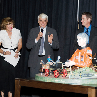 A NOTABLE MAN Ñ Sid Gutierrez reacts to seeing the bulto in his honor at the 2010 Notable New Mexican Gala on June 2. Artist Arthur Lopez is second from right. (Photo by Jean-Paul Jager)