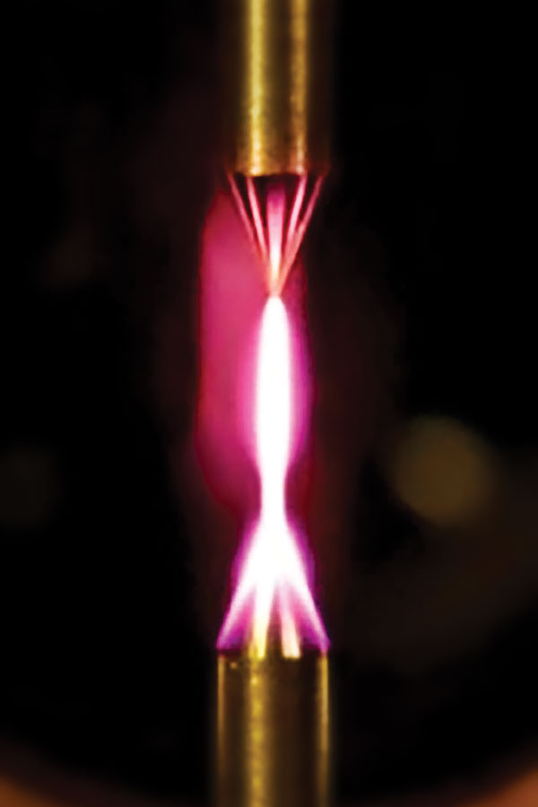 UNDER PRESSURE — Plasma is generated in atmospheric pressure helium between two tungsten electrodes for diagnostic development. (Photo courtesy of Ed Barnat)