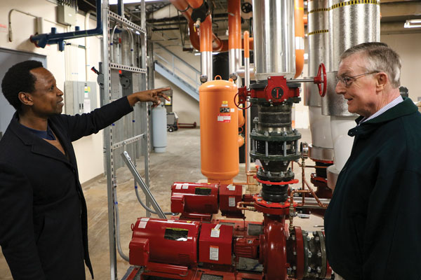 SMALL-BIZ FORWARD — nStone project manager Munene Kasina, left, and nStone President Donald Lincoln discuss a new hot water pump the small Albuquerque-based business helped install at Sandia.