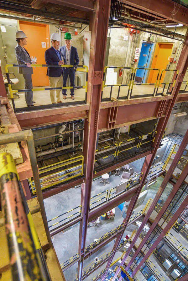 SUNGAZING — From inside the tower, Associate Labs Director Dori Ellis (left), U.S. Rep. Ben Ray Lujan and researcher Ken Armijo look down at three test bays.