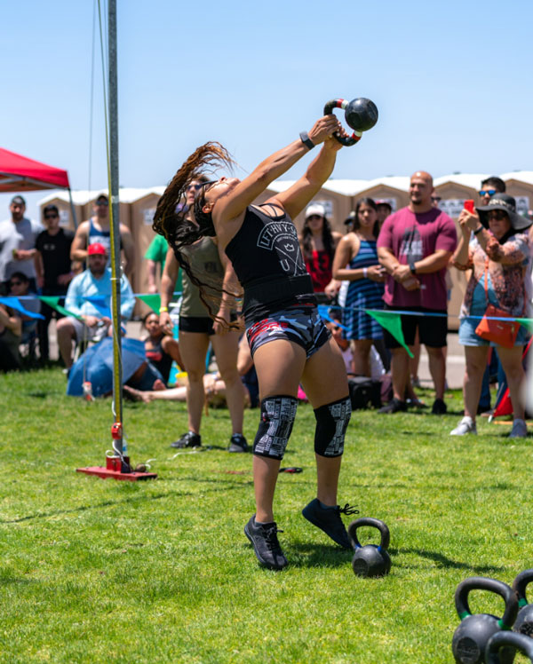 KETTLEBELL TOSS — Tiffany tossed two 18-pound kettlebells and two 25-pound kettlebells over 10 feet behind her and took first place in this event at the Rio Grande Celtic Strongman Games.