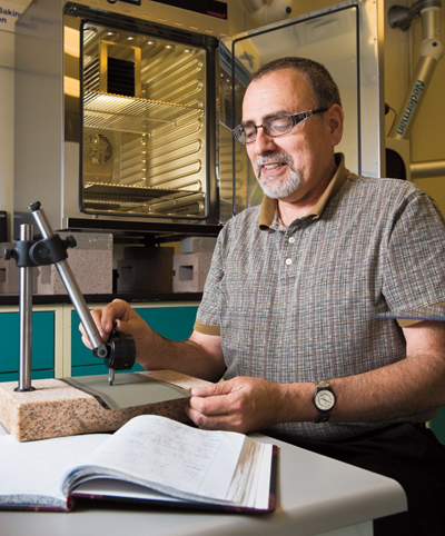 Sandia researcher Frank Delnick (2546) invented a thin-film coating process that changes the way certain thermal batteries have been made since the 1950s. Sandia and its industrial partner, ATB Inc., think the invention will reduce the size of certain thermal batteries and lower the manufacturing costs. 	(Photo by Randy Montoya)