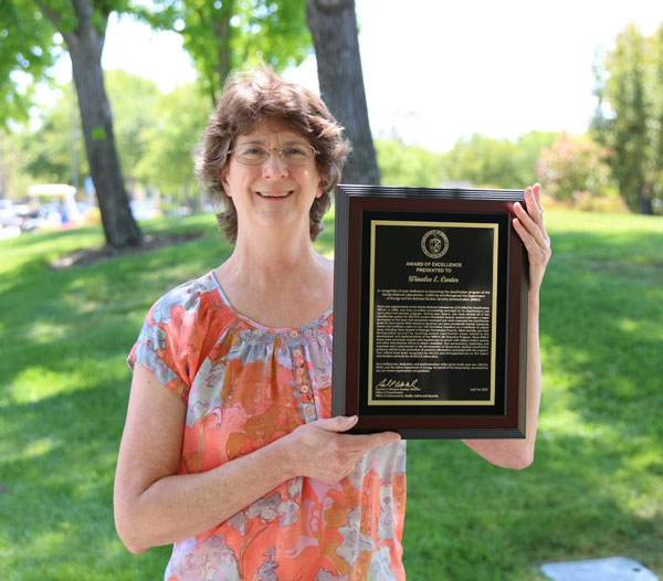 Winalee Carter displays her DOE Classification Award of Excellence.