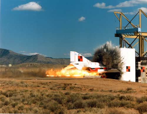 CRASH COURSE — To test the strength of concrete used in nuclear reactor containment, researchers launched an F-4 Phantom jet at 500 mph into a concrete wall. Data from this test advanced over time to inform new models. (Photo from video courtesy of Sandia Photometrics)