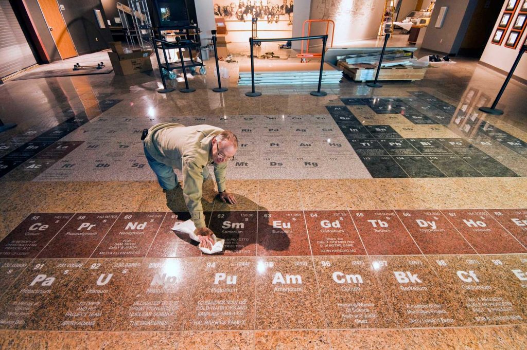 Image of Jim Walther polishes the museum entry on the day of its grand opening