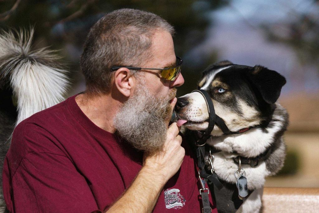 Image of A veteran interacts with his emotional support dog