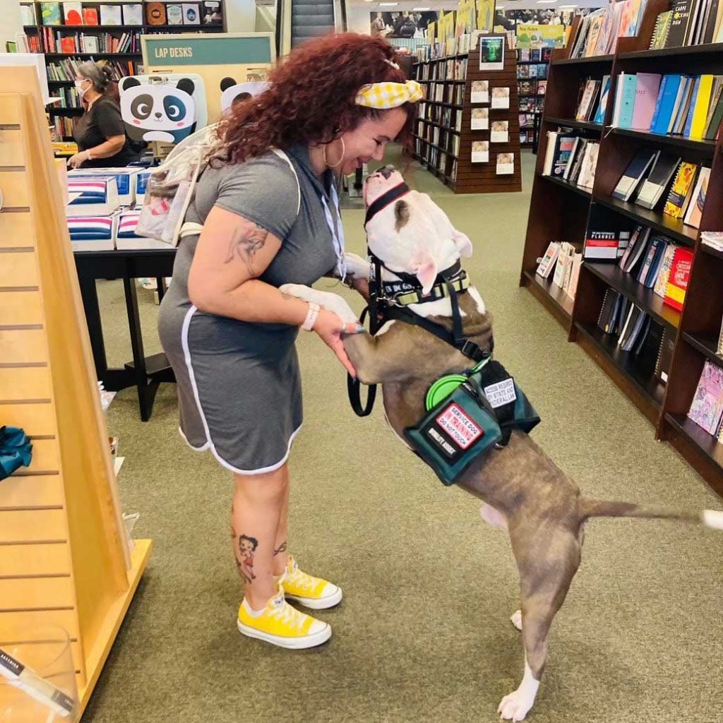Image of A veteran takes her service dog to the bookstore