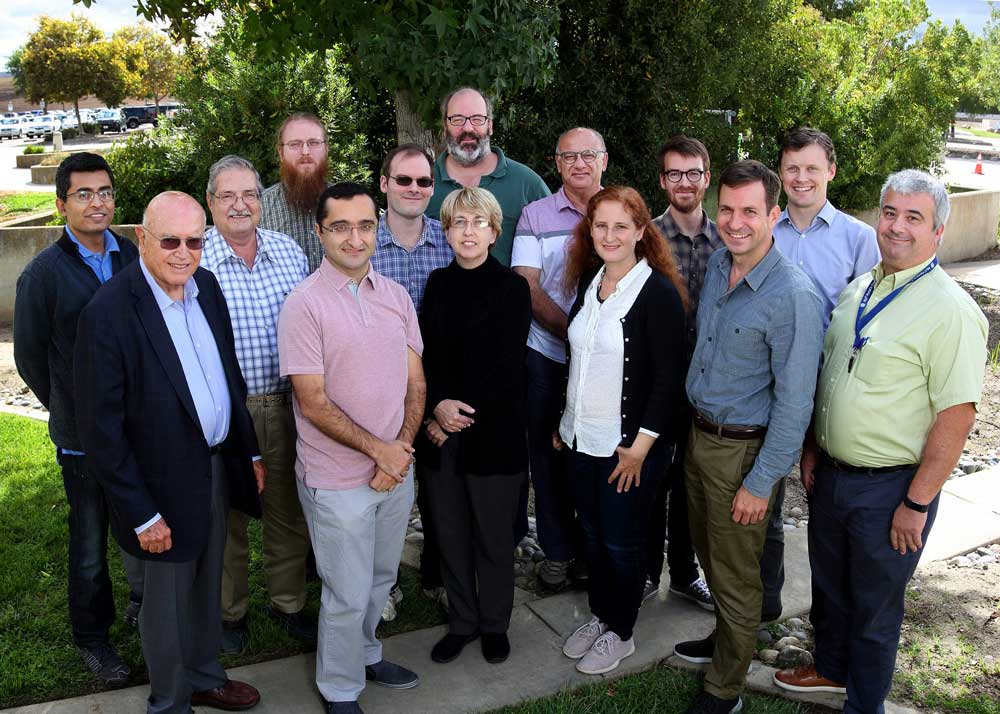 MODELERS — The Exascale Catalytic Chemistry team, photographed in 2018 with the members at that time, is composed of researchers from Sandia, Argonne and Pacific Northwest national laboratories, as well as Brown and Northeastern universities. (Photo by Dino Vournas)