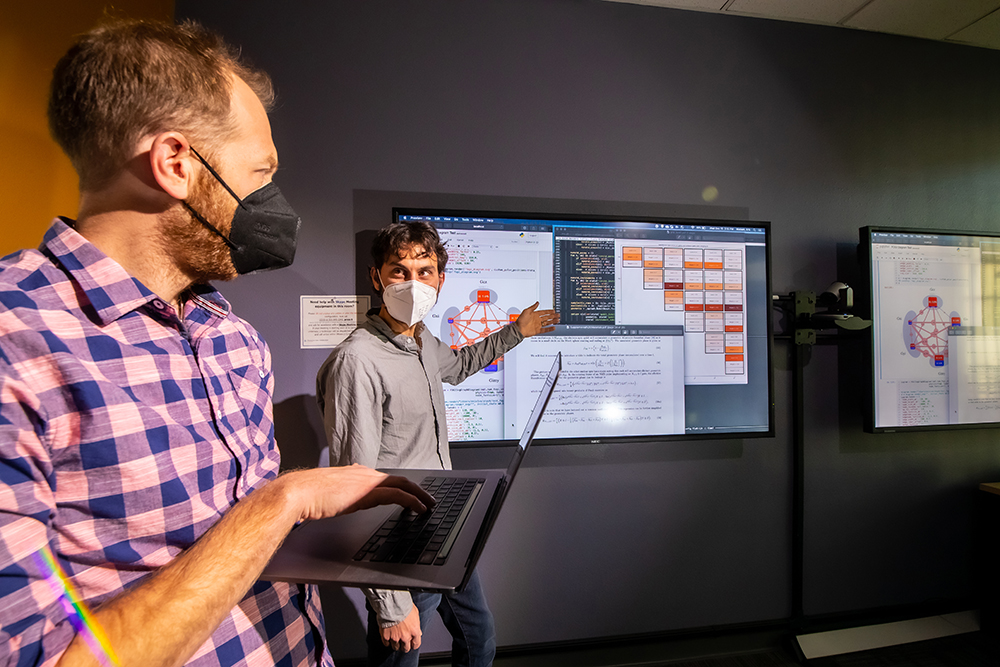 QUANTUM SNAPSHOT — Sandia researchers Andrew Baczewski, left, and Erik Nielsen use gate set tomography to analyze problems in a quantum processor. (Photo by Rebecca Gustaf)