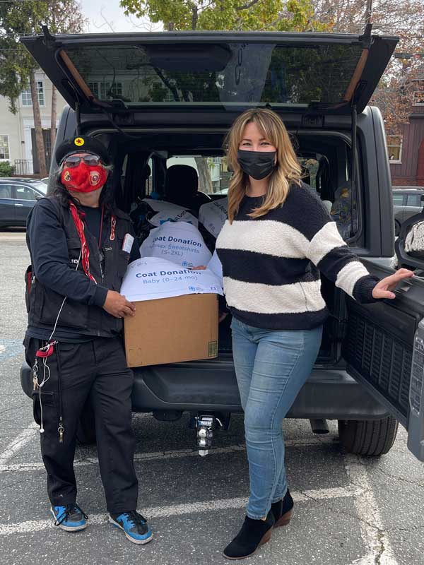 HEARTWARMING — Krissy Galbraith, right, delivered 105 new and used coats to the Central American Refugee Committee, a One Warm Coat partner in Oakland, California. (Photo courtesy of Krissy Galbraith)