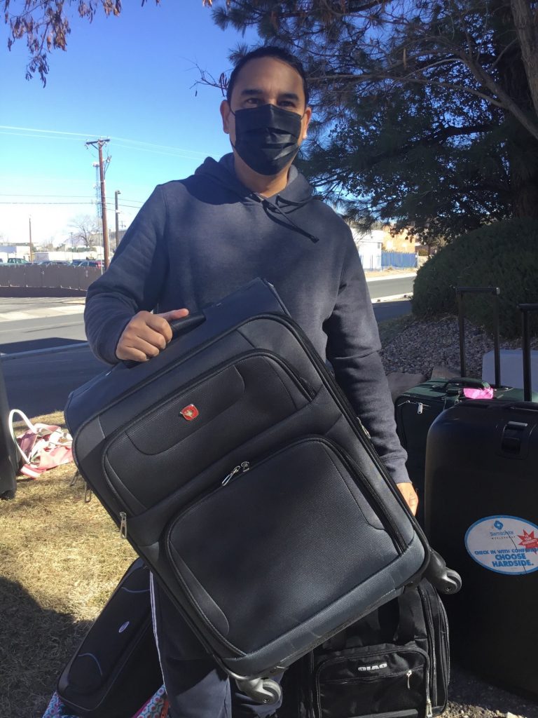 Image of Angel Urbina drops off luggage at the luggage drive