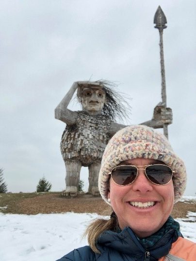 Image of Climate scientist Robin Jones poses with Joe the Guardian by artist Thomas Dambo