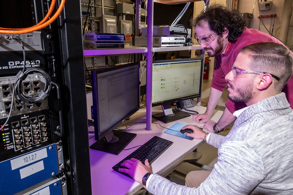 Image of Rachid Darbali-Zamora and Lee Raskin test an algorithm for a microgrid on the moon