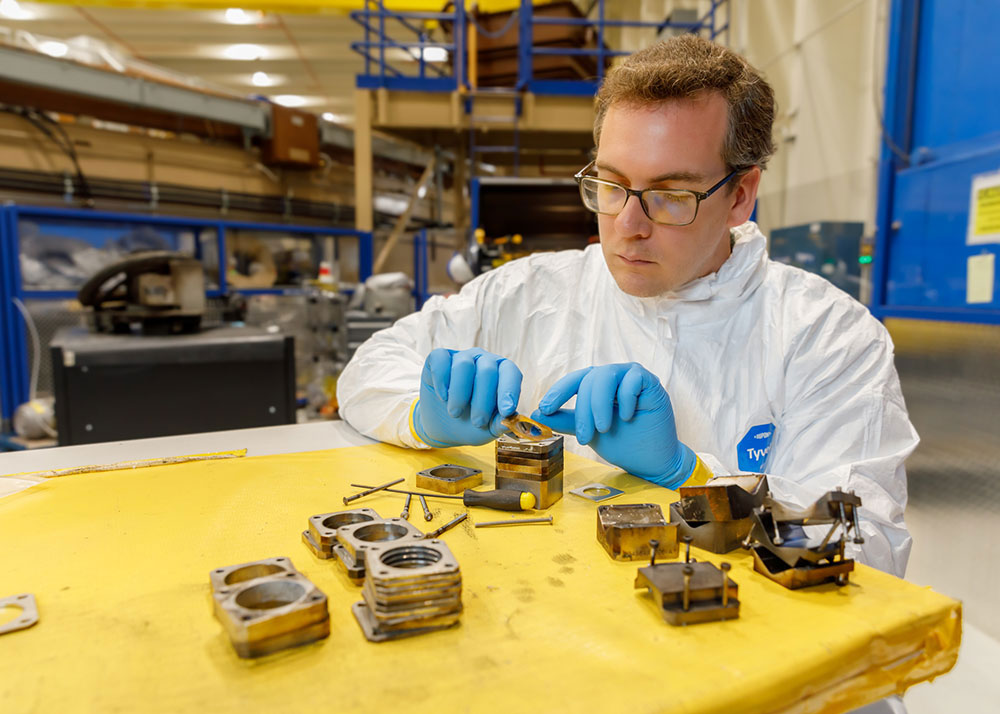 Image of Physicist Chad McCoy loads sample coatings into holders