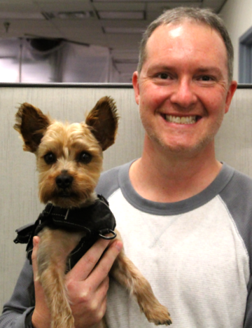 Image of Sandia technologist with his service dog Bear