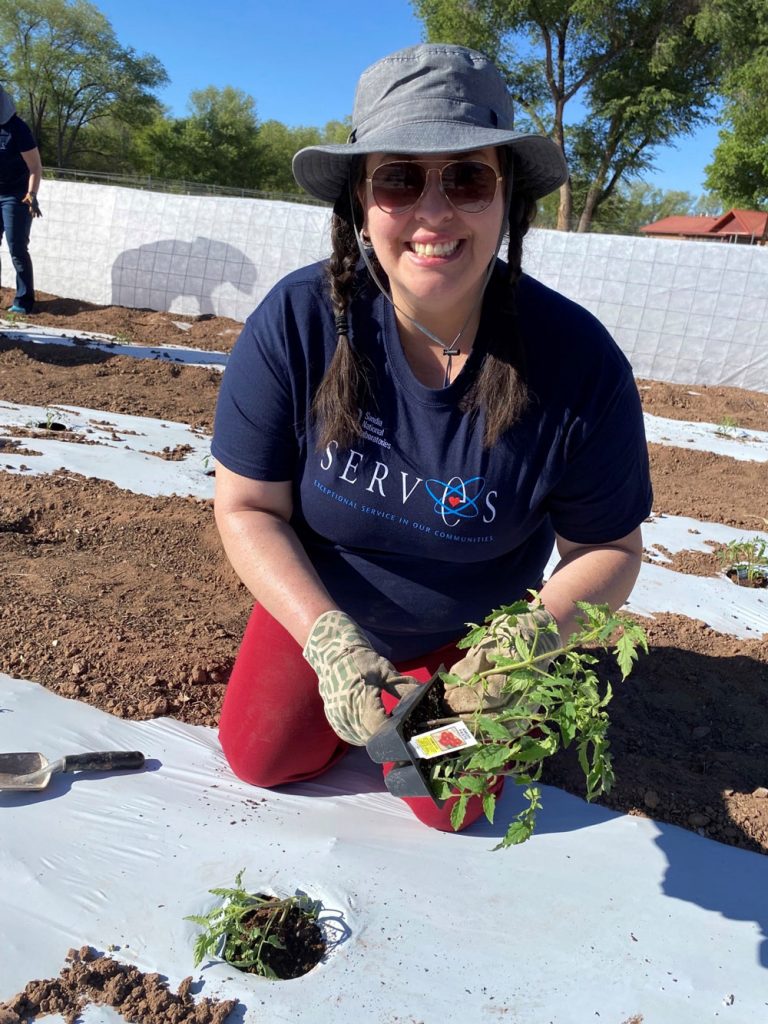 SPRING PLANTING — Tactical planner GiGi Forrest helped plant hundreds of tomato plants that will be grown to provide healthy food to people across New Mexico. Seed2Need has two gardens and an orchard located in Corrales on land donated by local property owners. Crops include tomatoes, cucumbers, watermelons, cantaloupe, green chile, green beans, squash, cabbage and broccoli.(Photo by Katrina Wagner)
