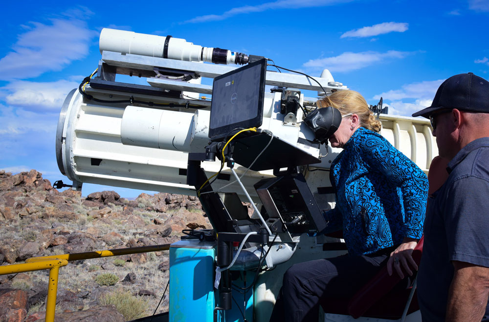 Image of Laura McGill looks into TTR ME-16 telescope