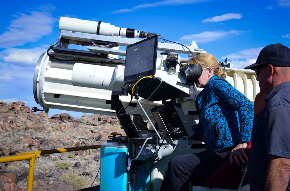 TONOPAH TELESCOPE — Deputy Labs Director Laura McGill, left, gets firsthand operator experience with Jim Rini in a TTR ME-16 telescope. The telescope is used to provide high speed documentary video. (Photo by David Coleman)