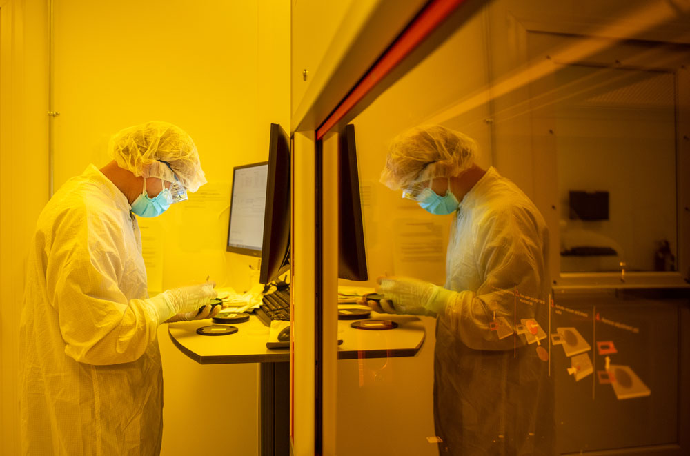 TINY PATTERNS — Computer scientist Anh Luong works in a clean room at Sandia’s Center for Integrated Nanotechnologies to add patterns to a laser sample. Work performed at CINT is one example of science and technology research that happens daily at Sandia. (Photo by Craig Fritz)