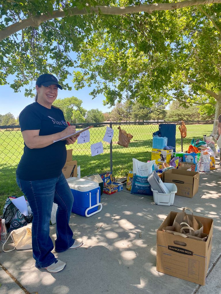 HELPING FURRY FRIENDS&nbsp;—&nbsp;Researcher Elizabeth Morris sorts donations at Sandia’s Advancing the Next Generation of Leadership Excellence’s Homeward Bound pet drive. Employees dropped off more than 125 pounds of dry dog food, 275 pounds of wet cat food and several boxes of dog toys, blankets, collars and treats at Sandia Laboratory Federal Credit Union locations in New Mexico to help homeless pets that are waiting for their forever homes. Lap Dog Rescue of New Mexico, Animal Humane New Mexico and June’s Senior Cats were among the organizations that received donations. (Photo courtesy of Advancing the Next Generation of Leadership Excellence)
