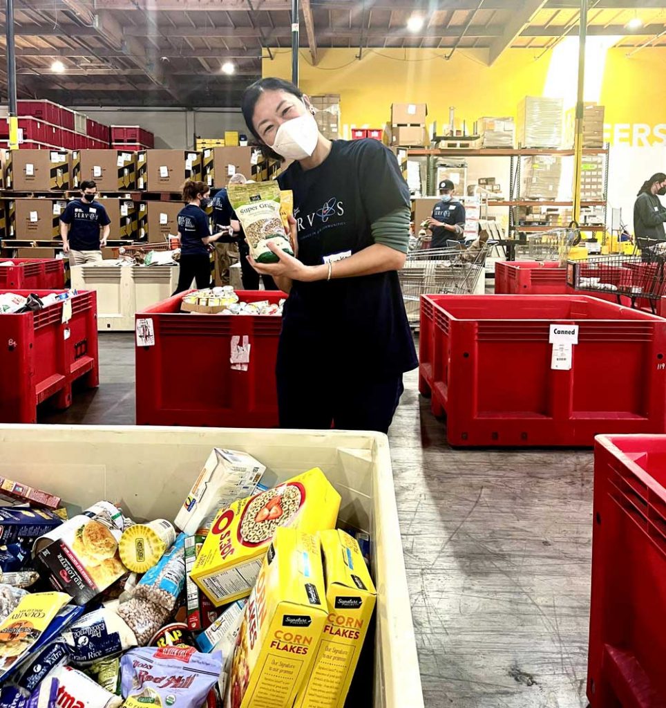 FOOD FOR ALL — Technologist Hiroko Suzuki helps sort food items at Alameda County Community Food Bank.
