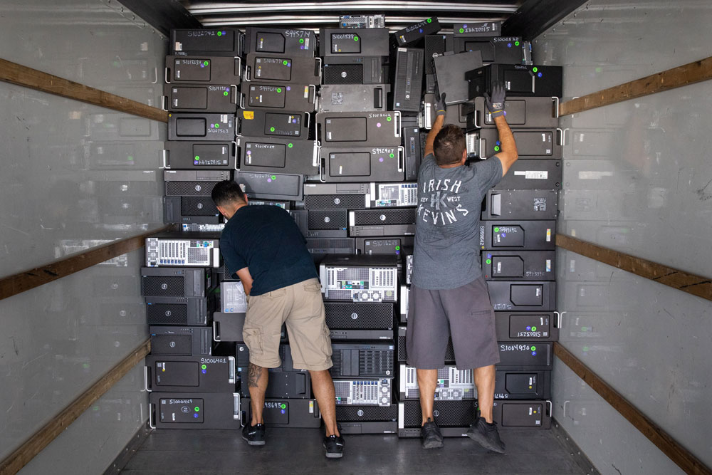 Image of Sandia Reapplication team members load computers for the annual Computer Donation Program