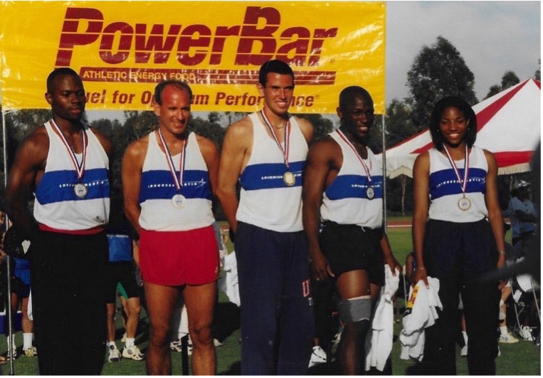 STAR RUNNER — Doug Deming, center, stands on the medal stand at the 1996 Corporate Cup at which Sandia competed on the Lockheed Martin team. (Photo courtesy of Doug Deming)