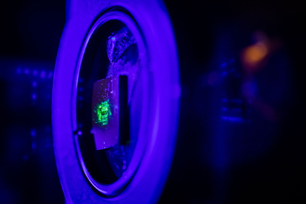 QUANTUM LOOKING GLASS — Green laser light illuminates a metasurface that is a hundred times thinner than paper, which was fabricated at the Center for Integrated Nanotechnologies. CINT is jointly operated by Sandia and Los Alamos national laboratories for the DOE Office of Science.(Photo by Craig Fritz)