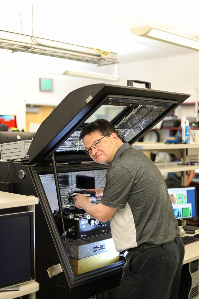 Image of HENAAC award winner Frank DelRio works on an atomic-force microscope