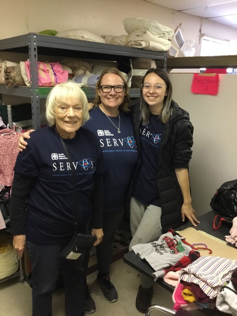 Image of Quality engineer Christine Salley, her mother Sharon and daughter Maggie volunteer to organize donations at (Re)Build Store with Rebuilding Together Sandoval County