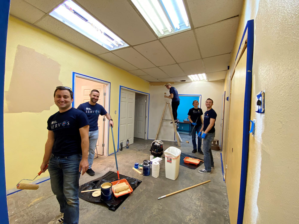 Image of Members of the Sandia Pride Alliance Network paint the halls of the Transgender Resource Center of New Mexico